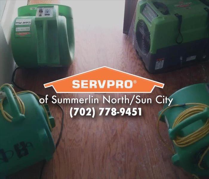 Four green SERVPRO air movers.