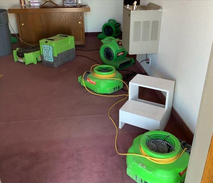 Carpet room with green air movers.