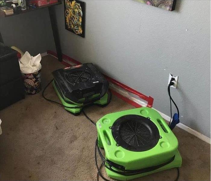 two air movers connected to a wall in a room